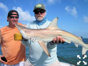 Jeff Stresing (left), from Parrish, FL, and Capt. Rick Grassett with a blacktip shark that Jeff caught and released on a threadfin while fishing the coastal gulf with Capt. Rick Grassett.