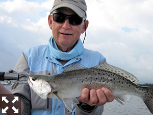 Ray Hutchinson, from MI, with a nice trout caught and released on a Clouser fly with Capt. Rick Grassett recently.