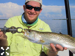 Raul Ortiz holds a nice trout he caught and released in a previous August with Capt. Rick Grassett.
