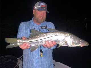 Dave King, from Dillon, MT, with a nice snook he caught and released on a fly while fishing at night with Capt. Rick Grassett.