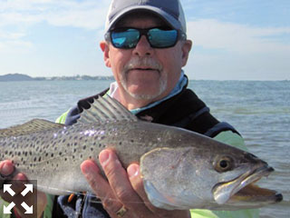 Mike Perez, from Sarasota, waded a sandbar in a previous February with Capt. Rick Grassett and caught and released this big trout on a fly.