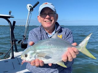 Ray Hutchinson, from MI, with a pompano caught on a Clouser fly while fishing deep grass flats of Sarasota Bay with Capt. Rick Grassett in a previous December.