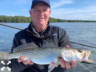 Kirk Grassett, from Middletown, DE, with a trout he caught and released on a CAL jig with a shad tail while fishing Sarasota Bay with Capt. Rick Grassett recently.