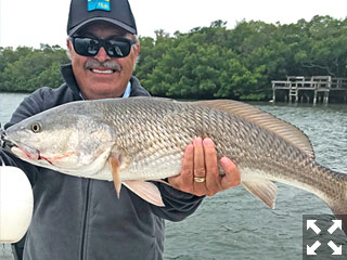 My brother Jack displaying a beautiful redfish.
