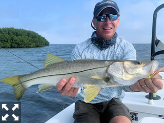 Dave Reinhart, from MA, with 28″ snook caught and released on a CAL jig with a grub while fishing the Bay.