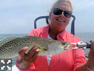 Susan Wayde, from Bloomfield Hills, MI, with a nice trout caught and released on a Clouser fly while fishing Sarasota Bay with Capt. Rick Grassett recently.