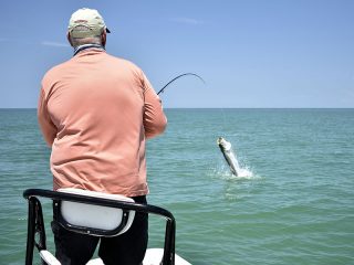 Clark Keator, from Orlando, fights a tarpon on fly tackle while fishing the coastal gulf with Capt. Rick Grassett in a previous June.