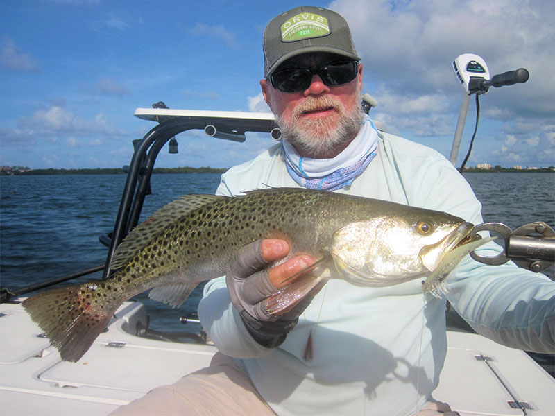 There should be good action in shallow water early in the day in July. Capt. Rick Grassett caught and released this trout on a DOA Deadly Combo while fishing Sarasota Bay in a previous July.