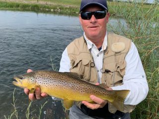 Kirk Grassett, from Middletown, DE, with a nice brown trout caught and released on a fly while fishing with King Outfitters out of Dillon, MT recently.