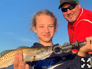 Harper Perez and her dad, Scott Perez, from Indianapolis, with a trout caught and released on a CAL jig with a shad tail while fishing Sarasota Bay with Capt. Rick Grassett recently.