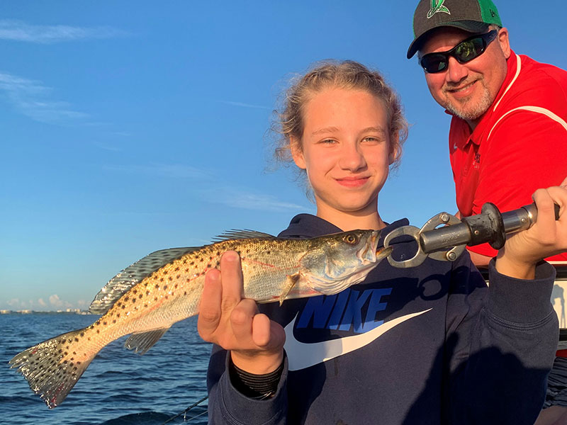 Harper Perez and her dad, Scott Perez, from Indianapolis, with a trout caught and released on a CAL jig with a shad tail while fishing Sarasota Bay with Capt. Rick Grassett recently.