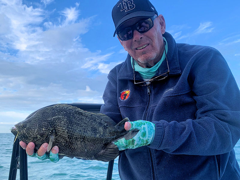 Steve Gibson, of Southern Drawl Kayak Fishing, with a tripletail caught and released on a fly while fishing with Capt. Rick Grassett.
