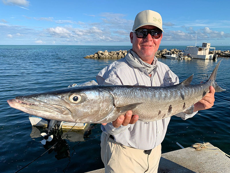 Kirk Grassett, from Middletown, DE, with a big 'cuda caught while fishing out of Mars Bay Bonefish Lodge.
