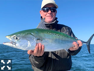 Kirk Grassett with a false albacore (little tunny) he caught and released on flies while fishing with Capt. Rick Grassett recently.
