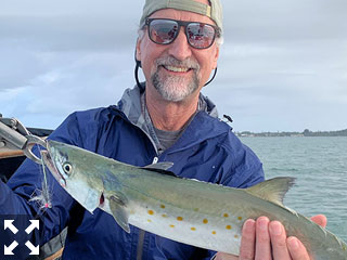 Taylor Owen, from CO, with a Spanish mackerel he caught and released on a Clouser fly while fishing Sarasota Bay with Capt. Rick Grassett this past week.