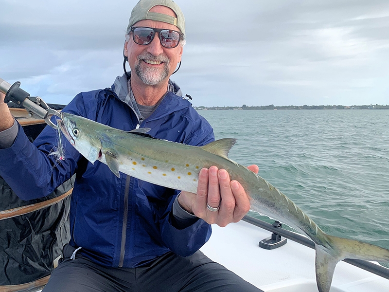 Taylor Owen, from CO, with a Spanish mackerel caught and released on a Clouser fly while fishing Sarasota Bay with Capt. Rick Grassett.