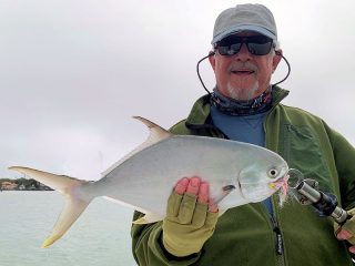 Bill Morrison, from Anna Maria Island, with a pompano caught while fishing Sarasota Bay with Capt. Rick Grassett.
