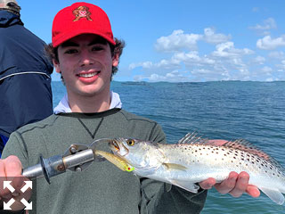 Chris Morrison, from MA, with a Sarasota Bay trout he caught on a CAL jig with a shad tail while fishing the Bay with Capt. Rick Grassett recently.