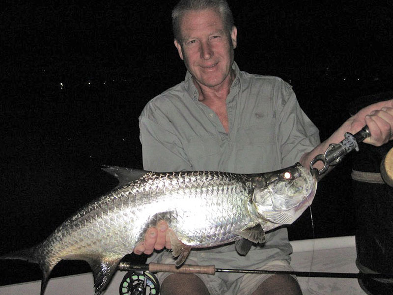 James Lascelles, from the UK, with a tarpon caught and released on a Grassett Snook Minnow fly while fishing dock lights before dawn with Capt. Rick Grassett in a previous September.