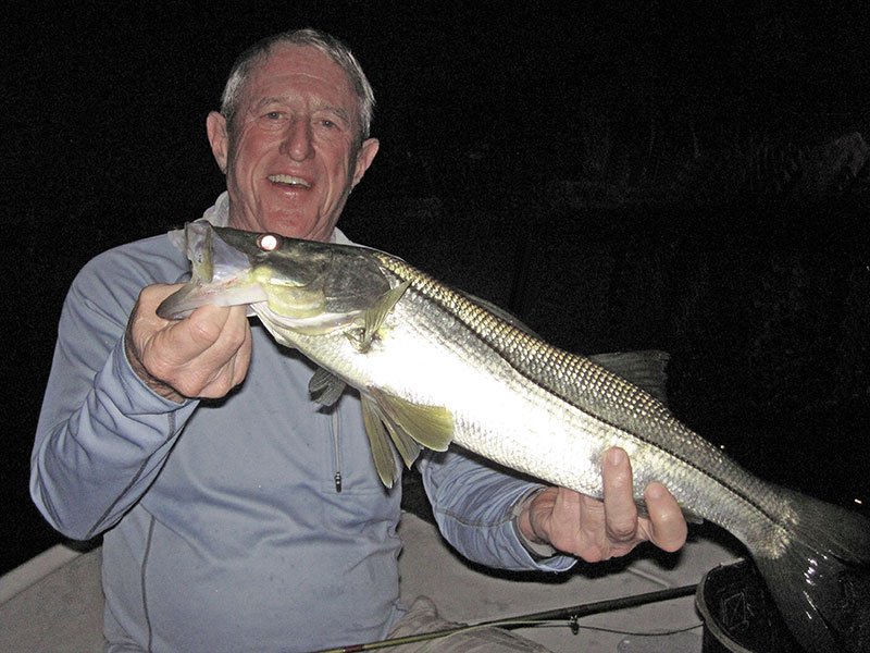 Marshall Dinerman, from Lido, with a snook caught and released on a Grassett Snook Minnow fly while fishing dock lights before dawn with Capt. Rick Grassett in a previous September.