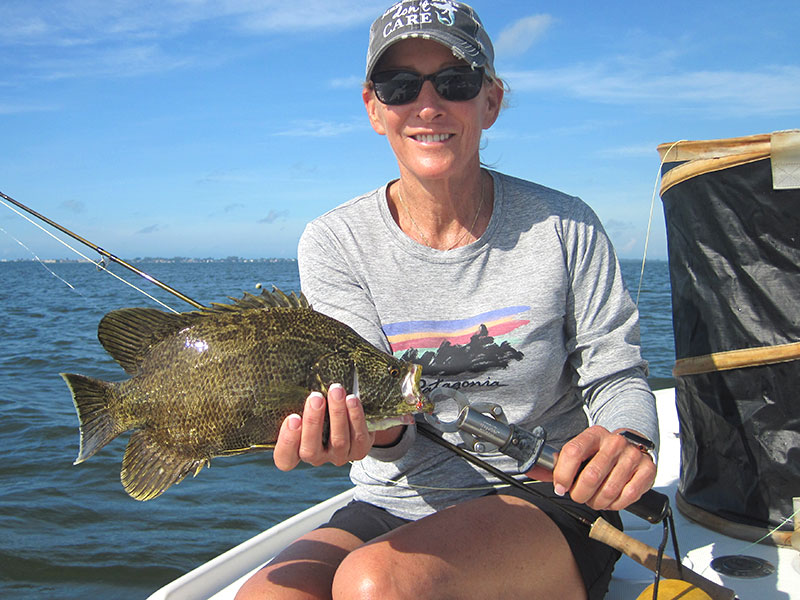 Sunny Moss, from Sarasota, with a tripletail caught and released on a fly while fishing with Capt. Rick Grassett in a previous October.