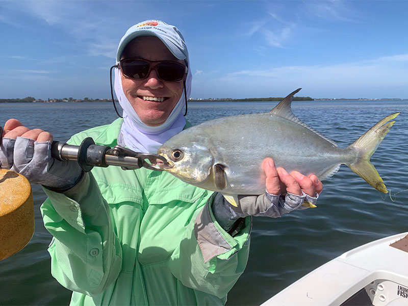 Ray Hutchinson, from MI, with a pompano he caught and released on Clouser flies while fishing Sarasota Bay with Capt. Rick Grassett on different trip in a previous March.