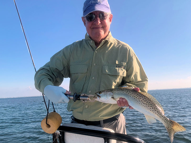 Alan Sugar, from Longboat Key, with a trout caught and released on a fly fishing Sarasota Bay.