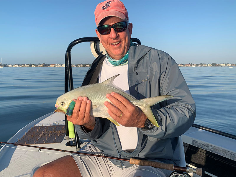 Tom Keir, from Cleveland, OH, with a pompano caught and released on a fly while fishing Sarasota Bay.