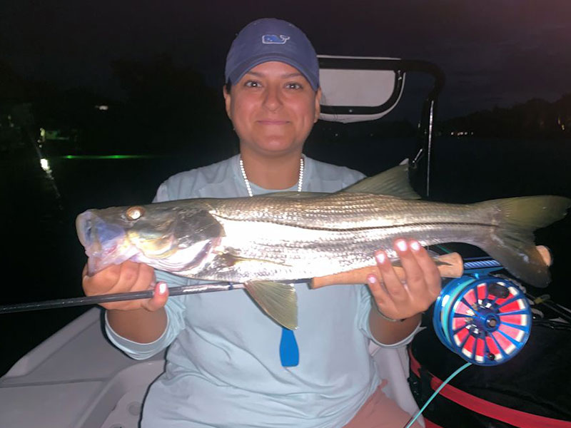 Emaly Rivera with her first tarpon caught on a saltwater fishing trip.