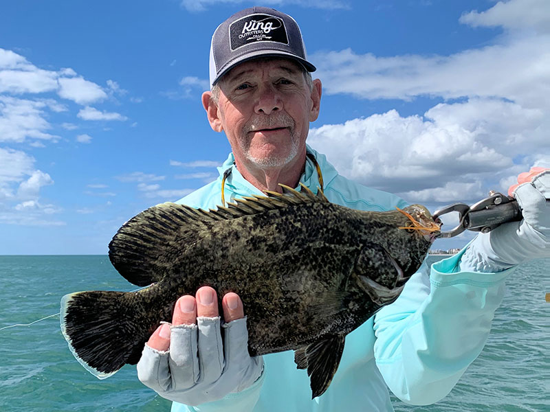 Mike Perez, from Sarasota, with a tripletail caught and released on a fly while fishing the coastal gulf with Capt. Rick Grassett recently.