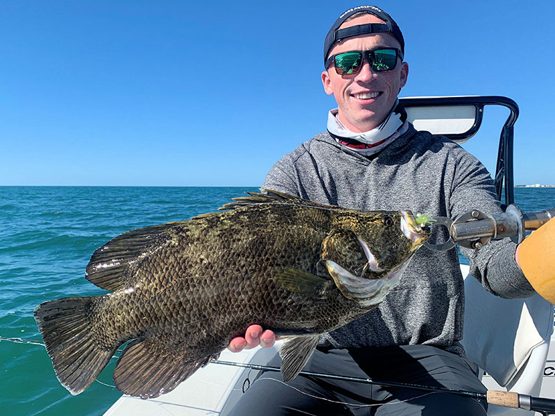 Denny Clohisy, from CA, with a tripletail caught while fishing with Capt. Rick Grassett in a previous December.