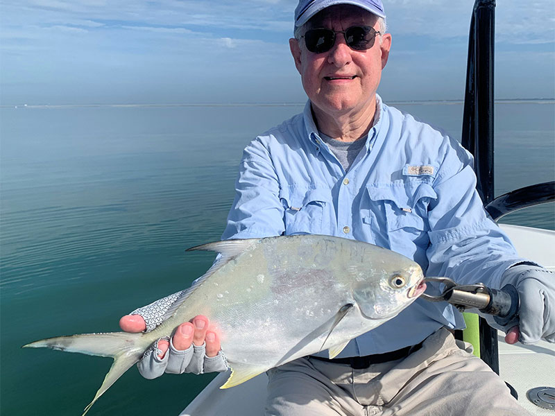 Alan Sugar, from MI, with a pompano caught and released on a Clouser fly while fishing Sarasota Bay with Capt. Rick Grassett recently.
