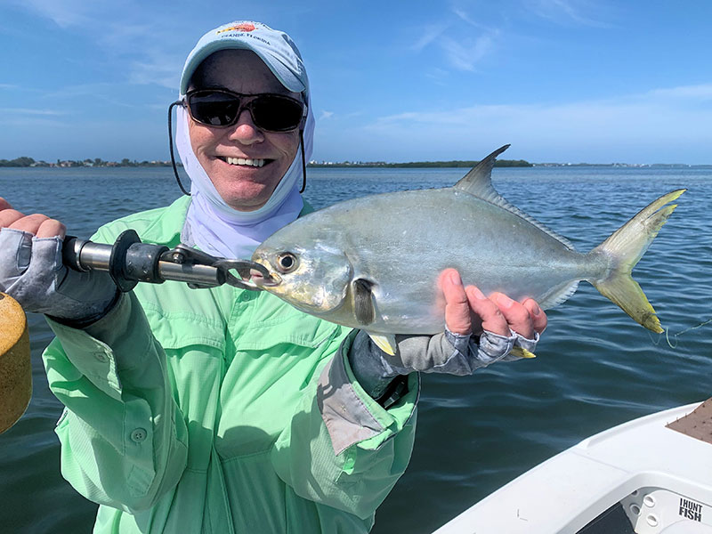 Ray Hutchinson, with a pompano, both caught and released in a previous March while fishing with Capt. Rick Grassett.