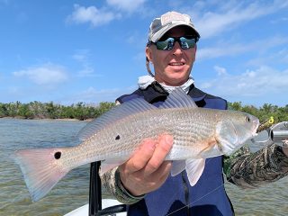 Dave Reinhart, from MA, with a red caught and released on a CAL jig with a shad tail while fishing Gasparilla Sound near Boca Grande with Capt. Rick Grassett recently.