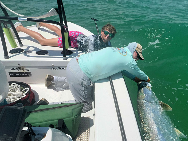 Capt. Rick Grassett and Mason Ondercin, from Sarasota, with a tarpon he caught and released in the Coastal Gulf.