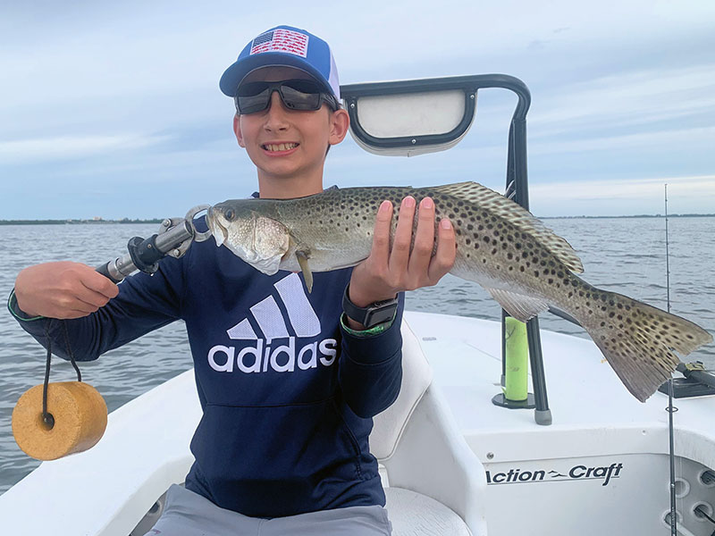 Connor Pullum, from NC, with a trout he caught and released in Sarasota Bay while fishing with Capt. Rick Grassett in a previous June.