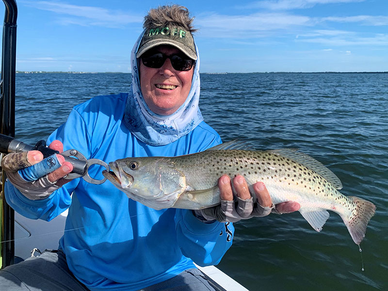 Ken Babineau, from Sarasota, with a trout caught on a fly and released while fishing with Capt. Rick Grassett in a previous August.