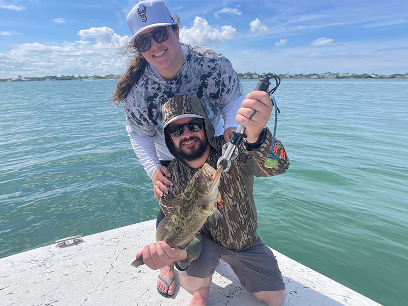 Paul Martinez, his wife, and a baby gag grouper.