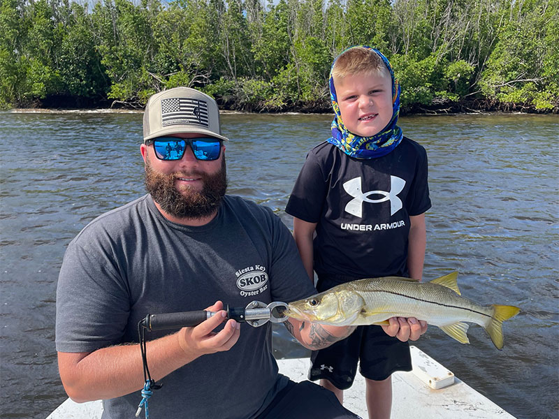 Brody and his dad with this beautiful Snook caught on a CB's Outfitters trip out of Siesta Key.