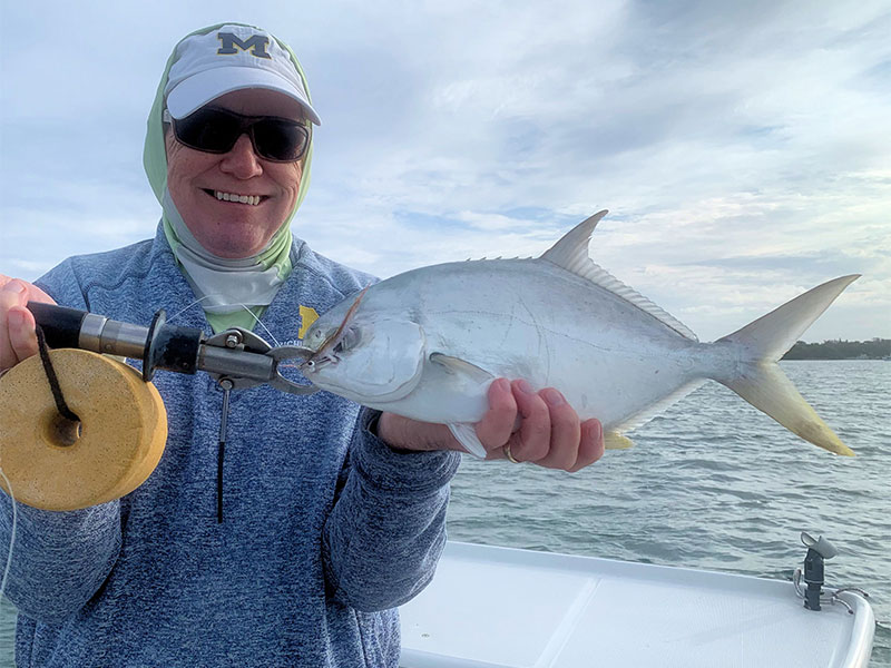 Ray Hutchinson, from Bradenton, with a pompano, caught and released while fishing Sarasota Bay with Capt. Rick Grassett in a previous December.